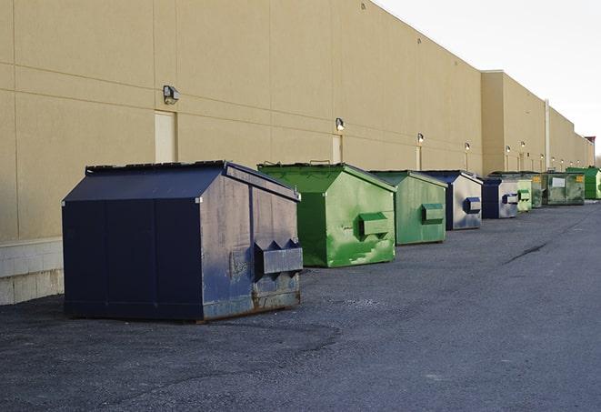 tilted front-load dumpsters being emptied by waste management workers in Cincinnati